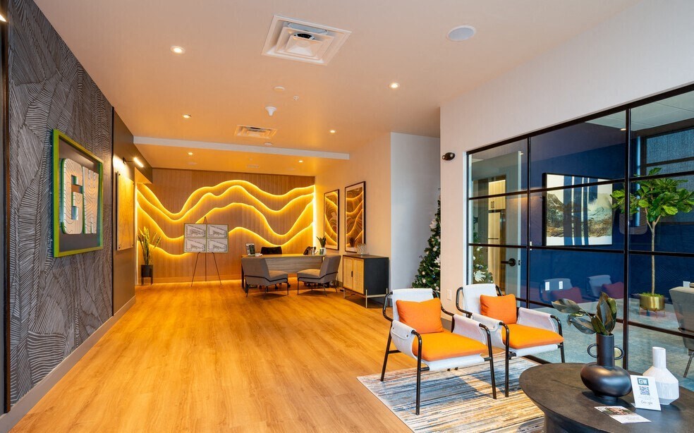 a living room with a wood floor and a large window