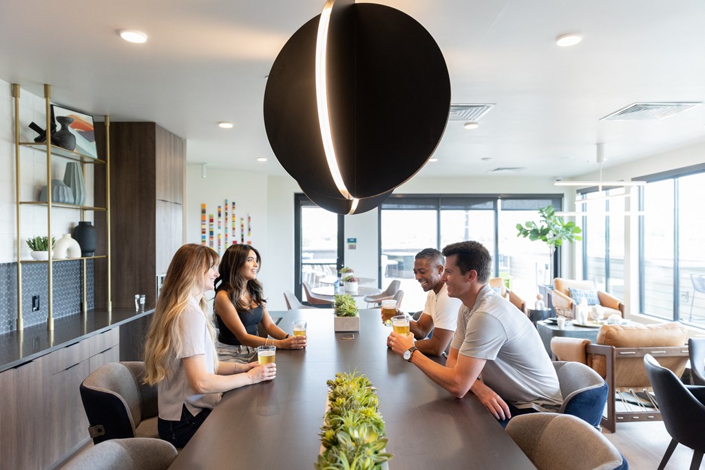 a group of people sitting at a long table in a restaurant