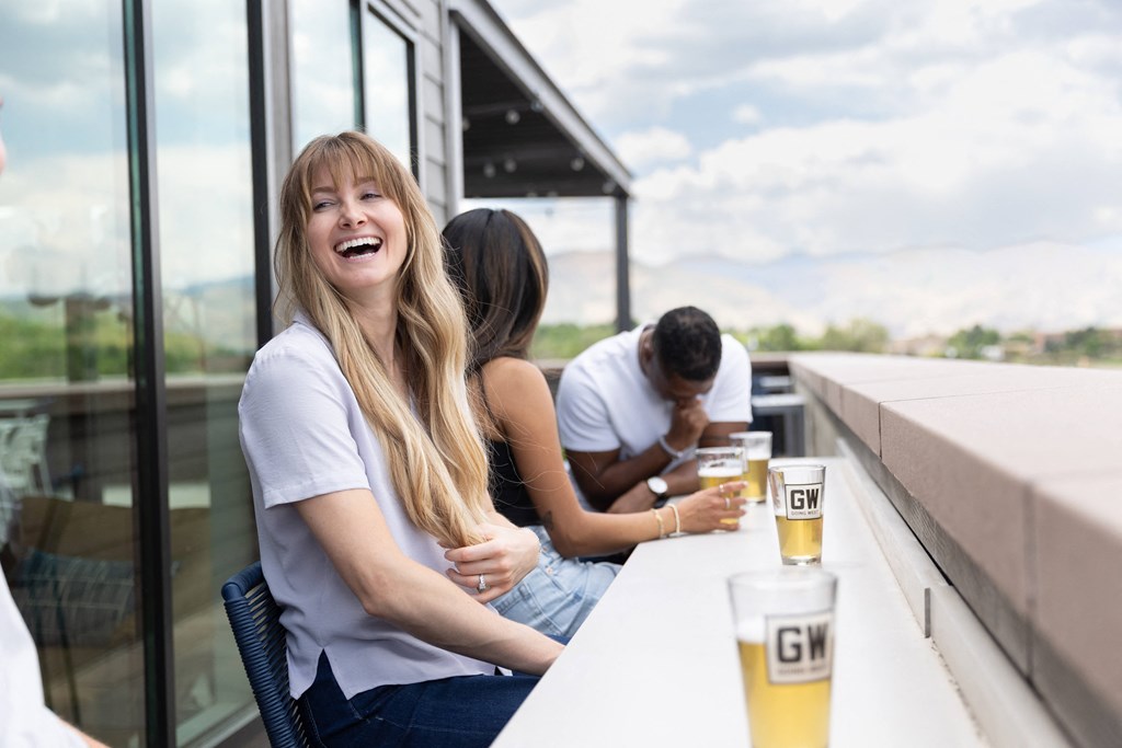 a group of people sitting at a bar with drinks