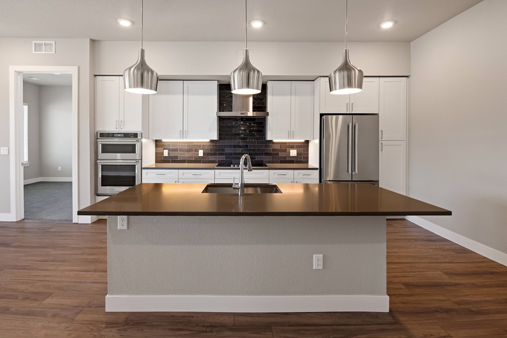 A modern kitchen with a large island in the center.