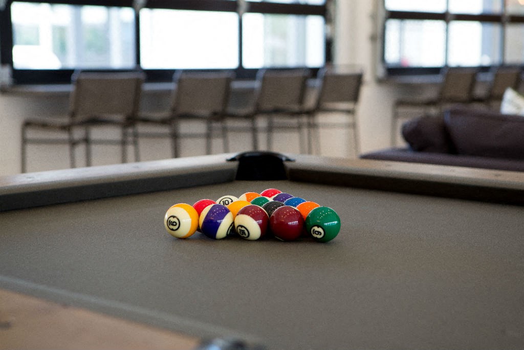 a pool table with a bunch of billiard balls on it
