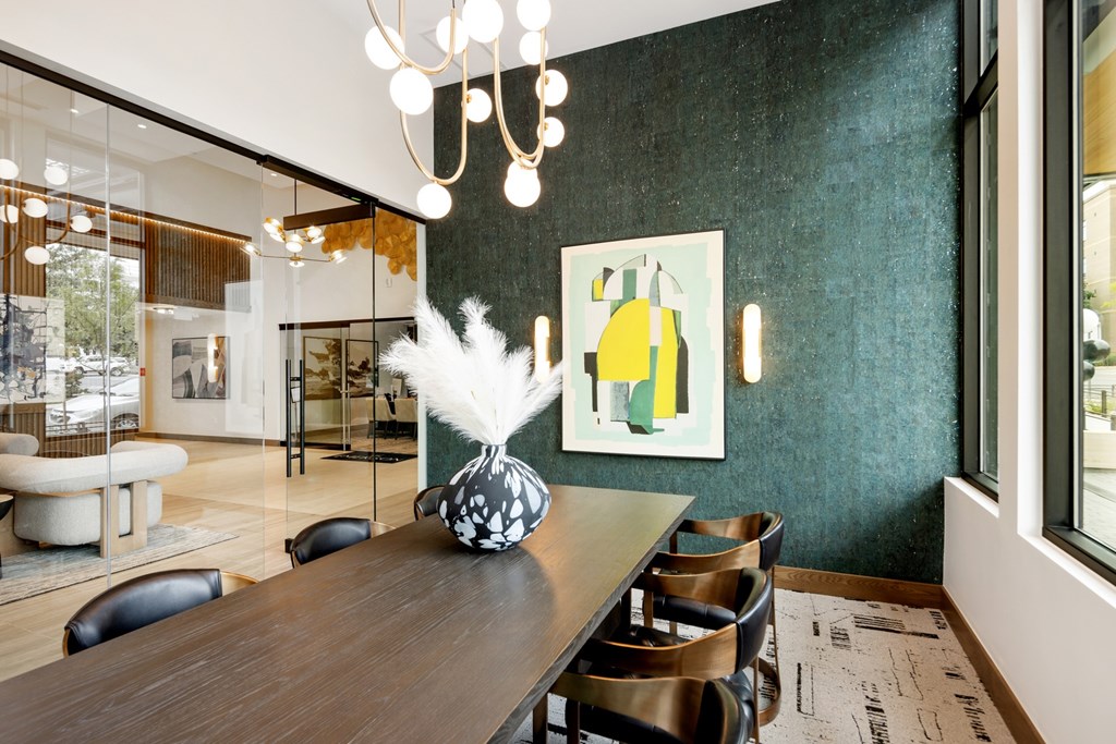 A dining room with a wooden table and chairs.