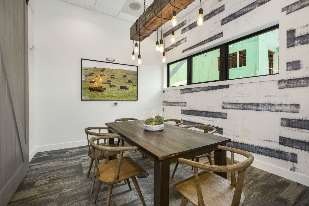 a dining room with a wooden table and chairs