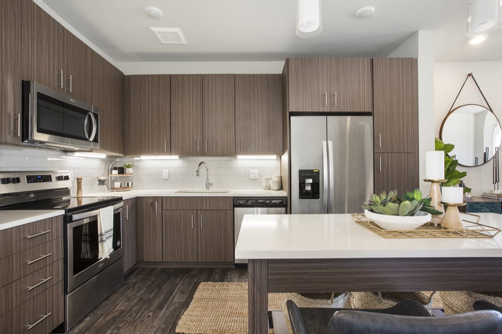a kitchen with stainless steel appliances and a white counter top