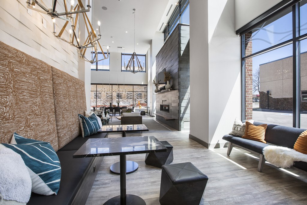 a living room with couches and tables and a fireplace