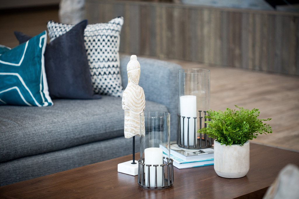 a living room with a couch and a coffee table with candles