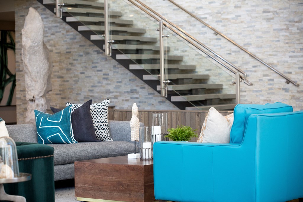 a living room with blue couches and a coffee table