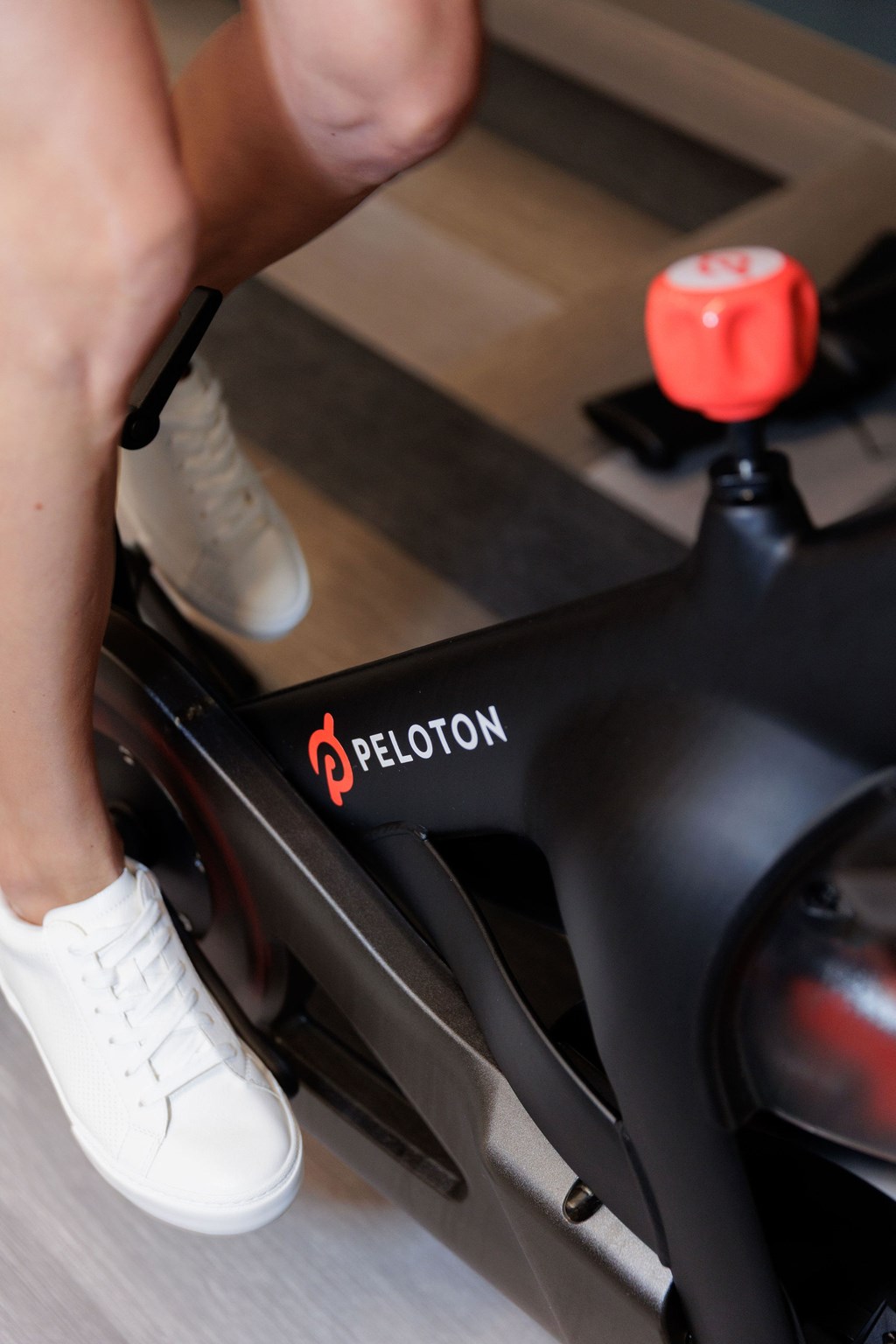 A person is riding a Peloton bike.