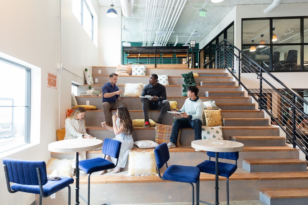a group of students sitting on the stairs in the catalyst building