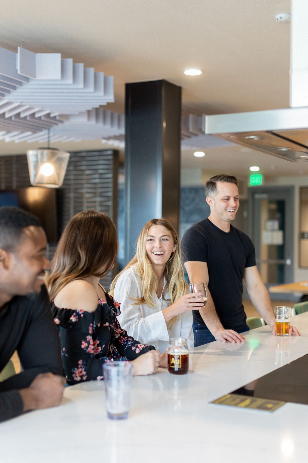 a group of people sitting at a bar with drinks