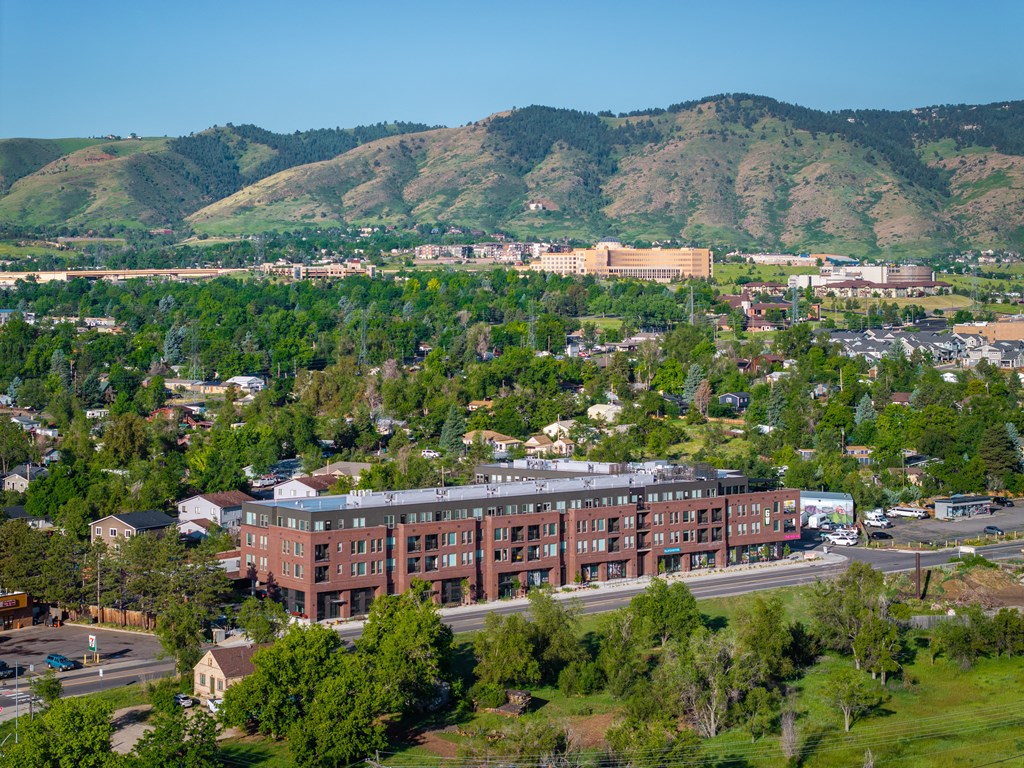 an aerial view of a city with mountains in the background