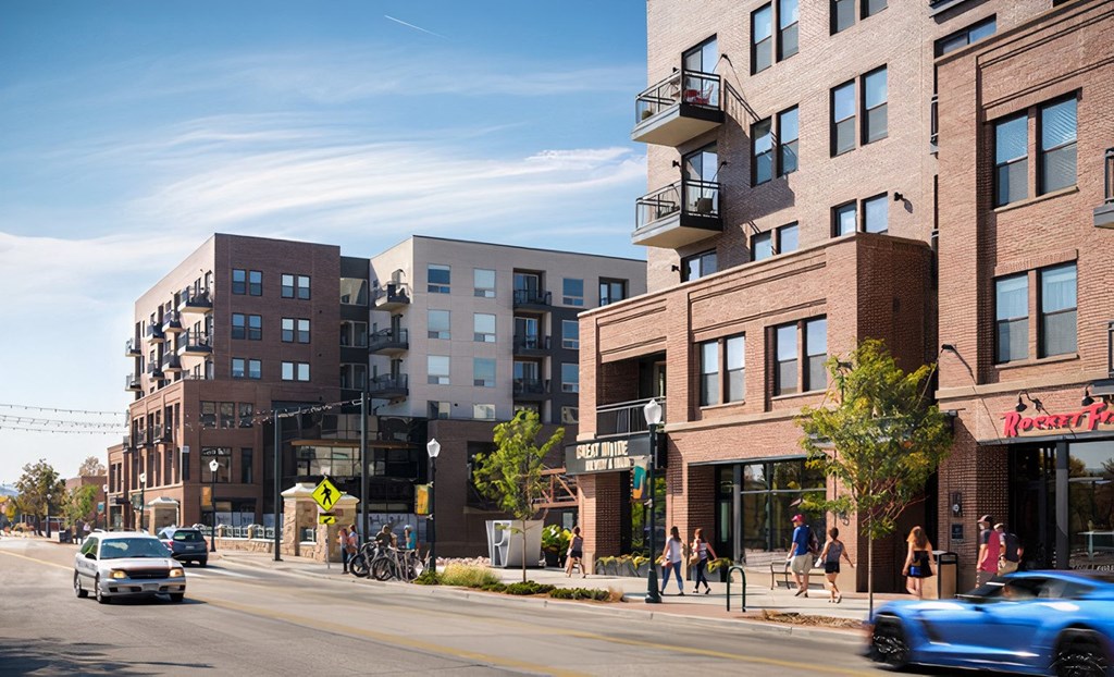 a city street with people walking and cars driving