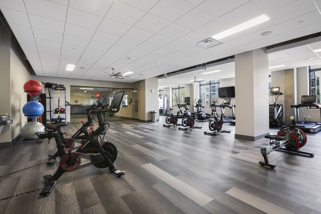 a workout room with exercise bikes and weights in a building