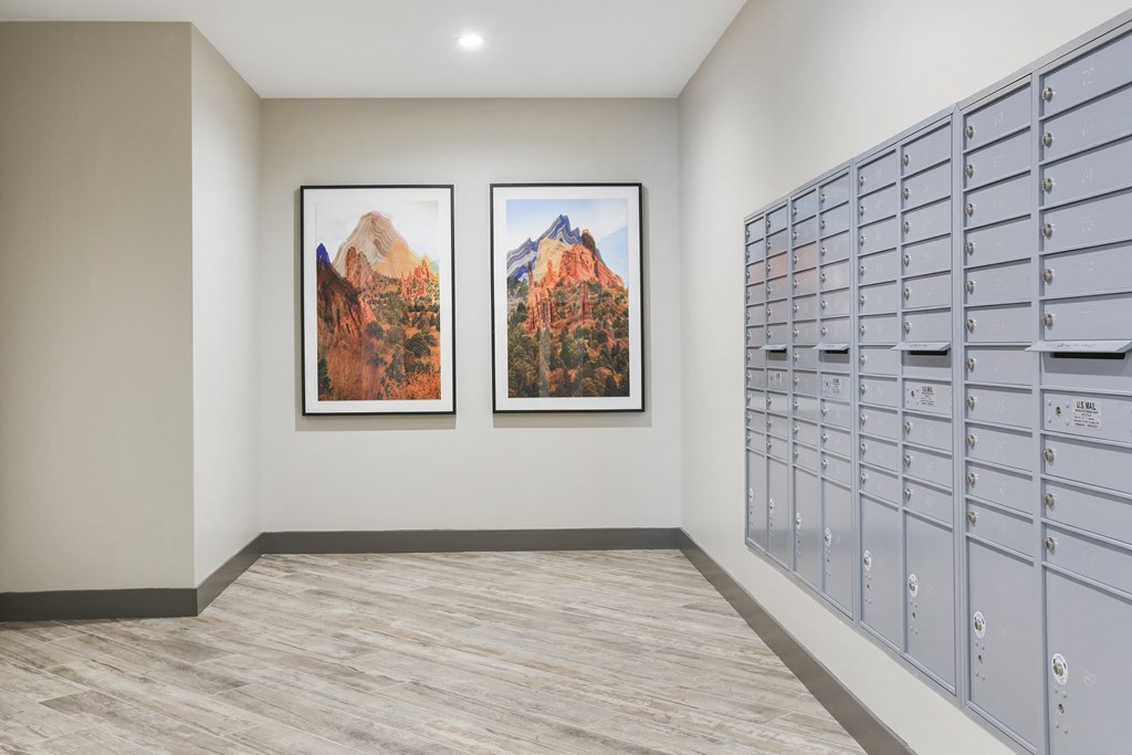 two pictures hanging on a wall next to lockers in a room