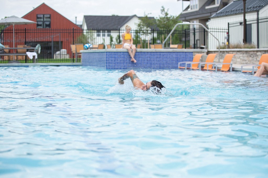 A person diving into a swimming pool.