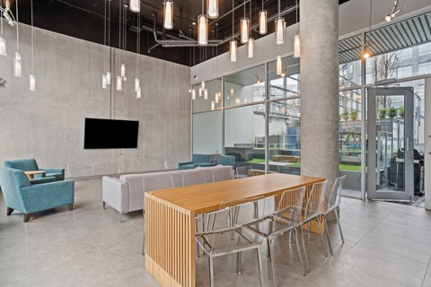 a communal table and chairs in a lobby of a building