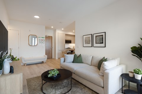 A living room with a white couch and a coffee table.