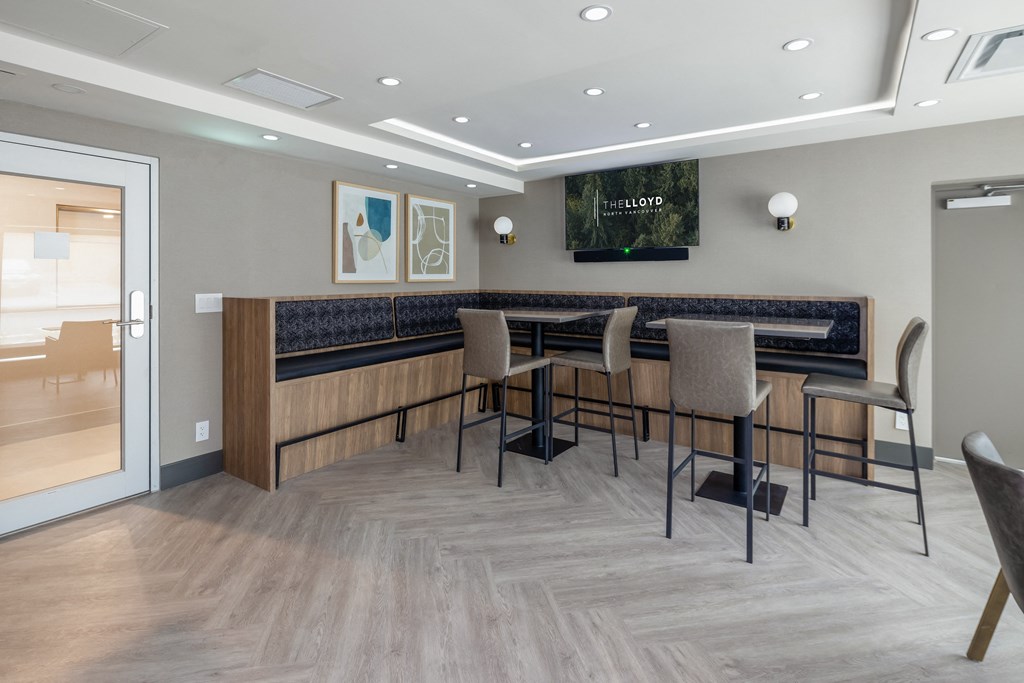 a communal area with a table and chairs in the lobby of a building