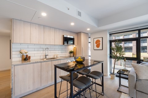 A modern kitchen with a dining table and chairs.