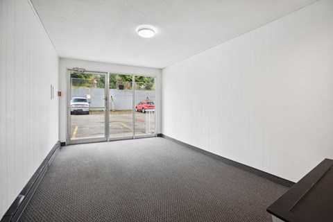 A hallway with a car parked outside the window.