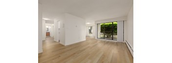 A room with wooden floors and white walls.