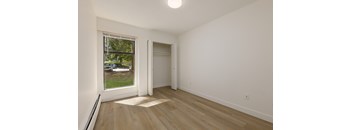 A room with a window and a door.