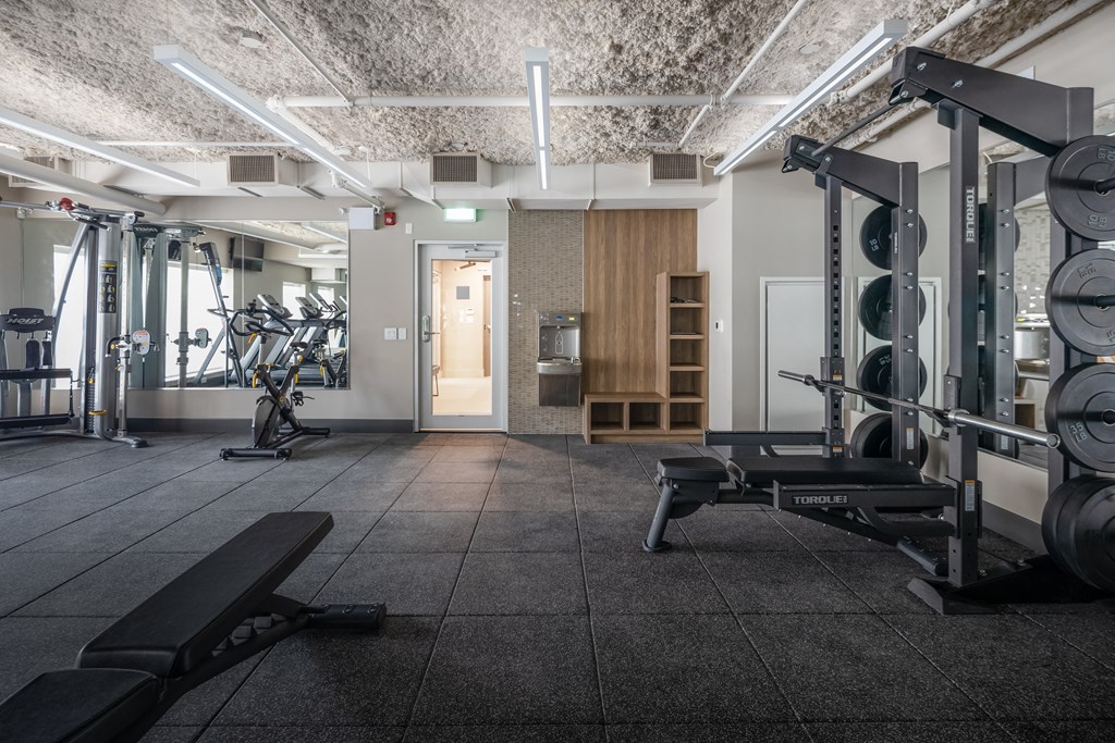 a gym with weights machines and a door