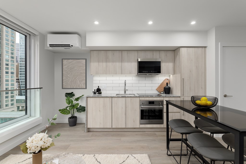 A modern kitchen with a dining table and chairs.