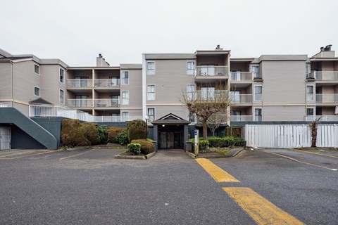 A parking lot in front of apartment buildings.