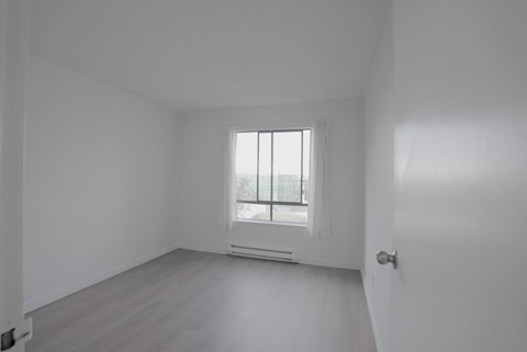 A room with a window and a door.