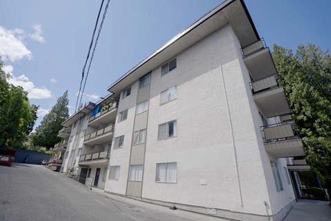 A white building with a balcony on the second floor.