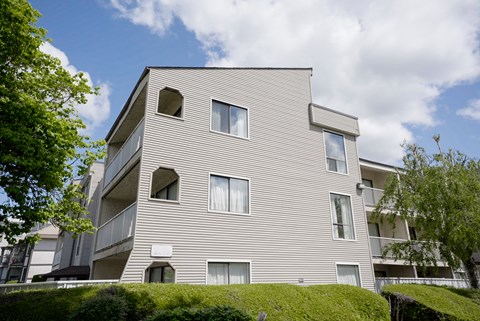 A modern building with a curved facade and multiple windows.