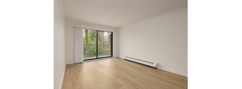 A room with a sliding glass door and a radiator on the floor.