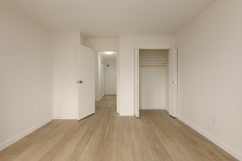 A room with a white door and a white wall.