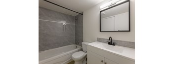 A bathroom with a white toilet and a white sink.