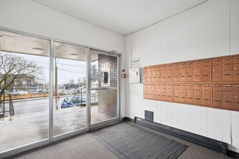 A room with a row of mailboxes on the wall.