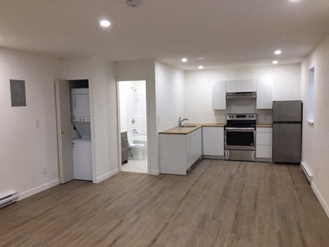 A kitchen with white cabinets and stainless steel appliances.