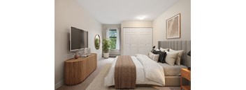 A bedroom with a large bed and a flat screen TV on a wooden cabinet.