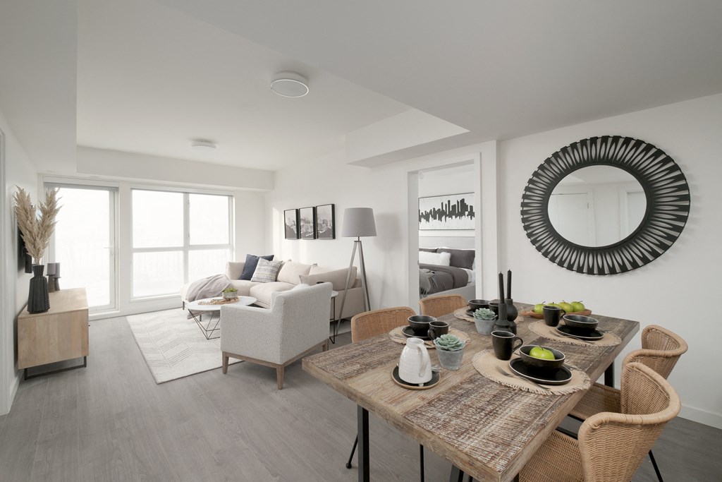 a living room and dining room with a table and chairs