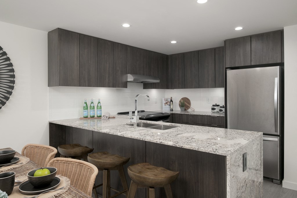 a kitchen with a marble counter top and a sink