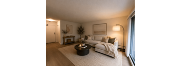 A modern living room with a white couch and a coffee table.