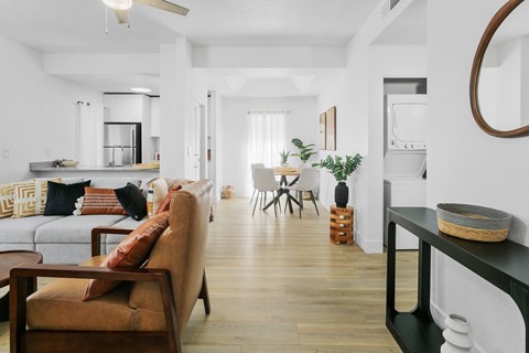 A living room with a brown sofa and a wooden coffee table.