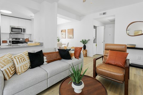 A living room with a grey couch and a brown chair.