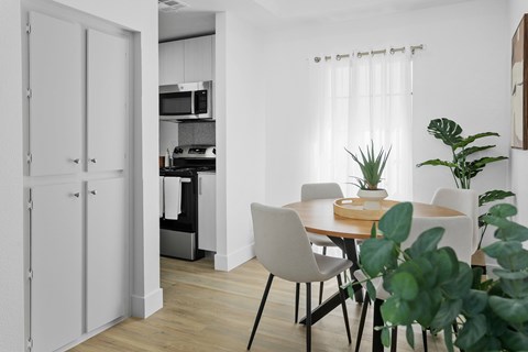 A dining area with a table and chairs is shown.