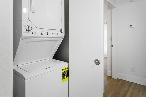 A white dishwasher with a yellow sticker on it.
