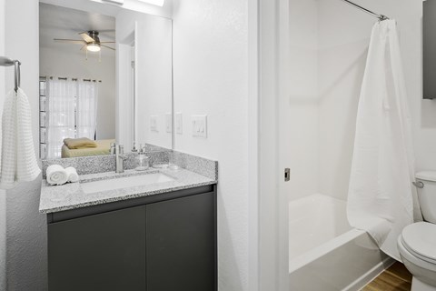 A bathroom with a white towel hanging on the wall.