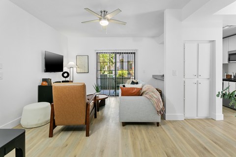A living room with a brown chair and a grey couch.