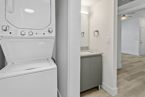 A white bathroom with a toilet, sink, and mirror.