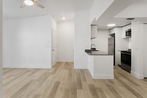 A kitchen with a white counter and black appliances.