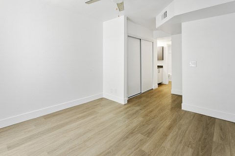 A room with a wooden floor and white walls.